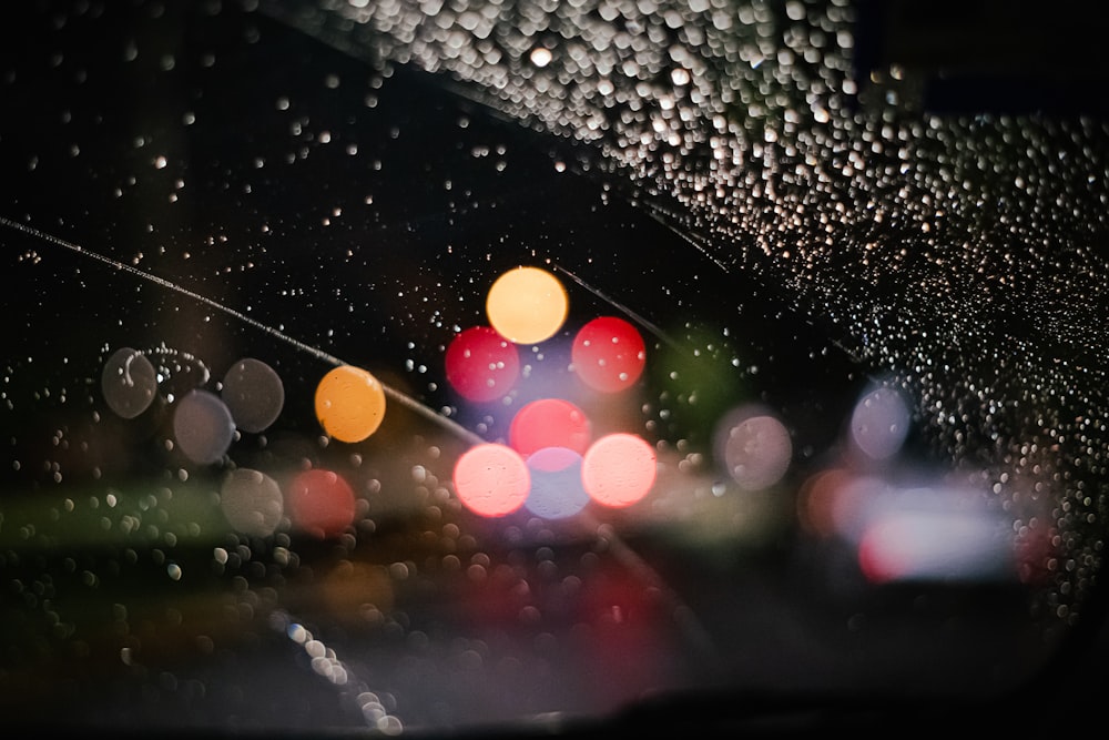 rain drops on the windshield of a car at night