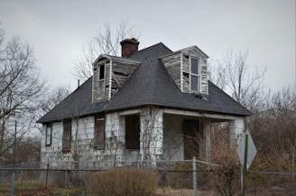 an old run down house with broken windows