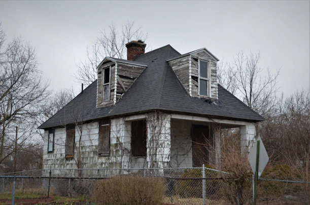 an old run down house with broken windows