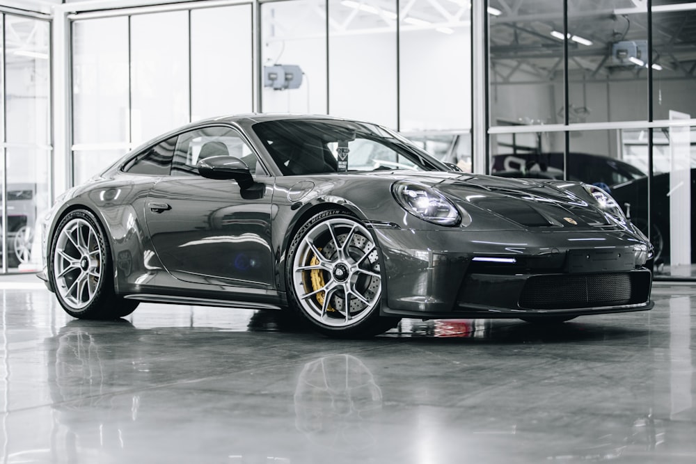 a grey sports car parked in a garage