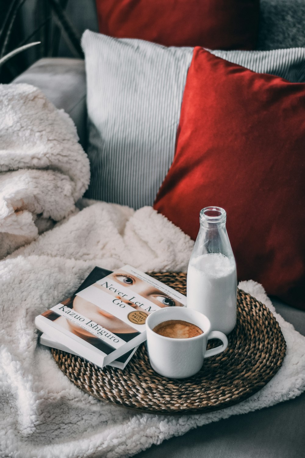 a bottle of milk and a cup of coffee on a tray
