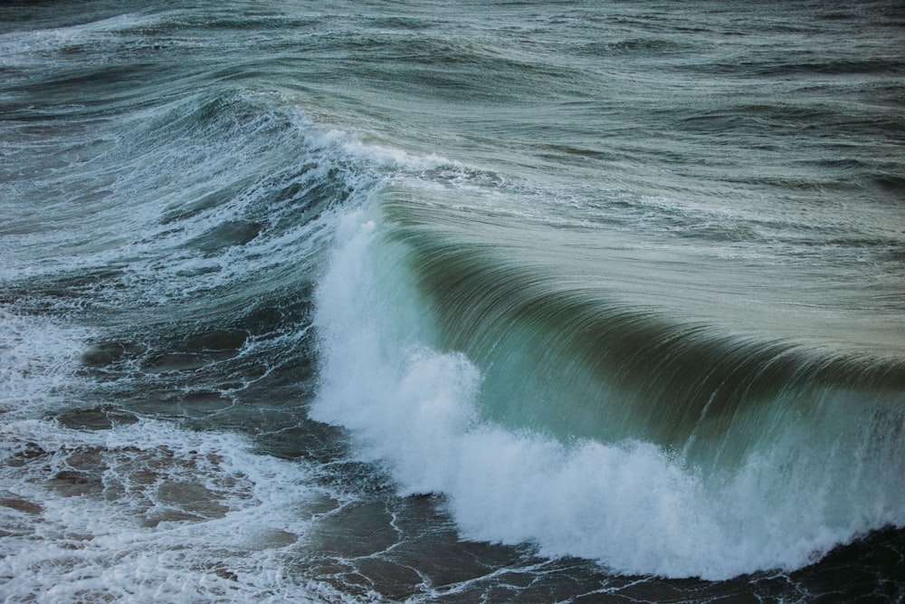 a man riding a wave on a surfboard in the water