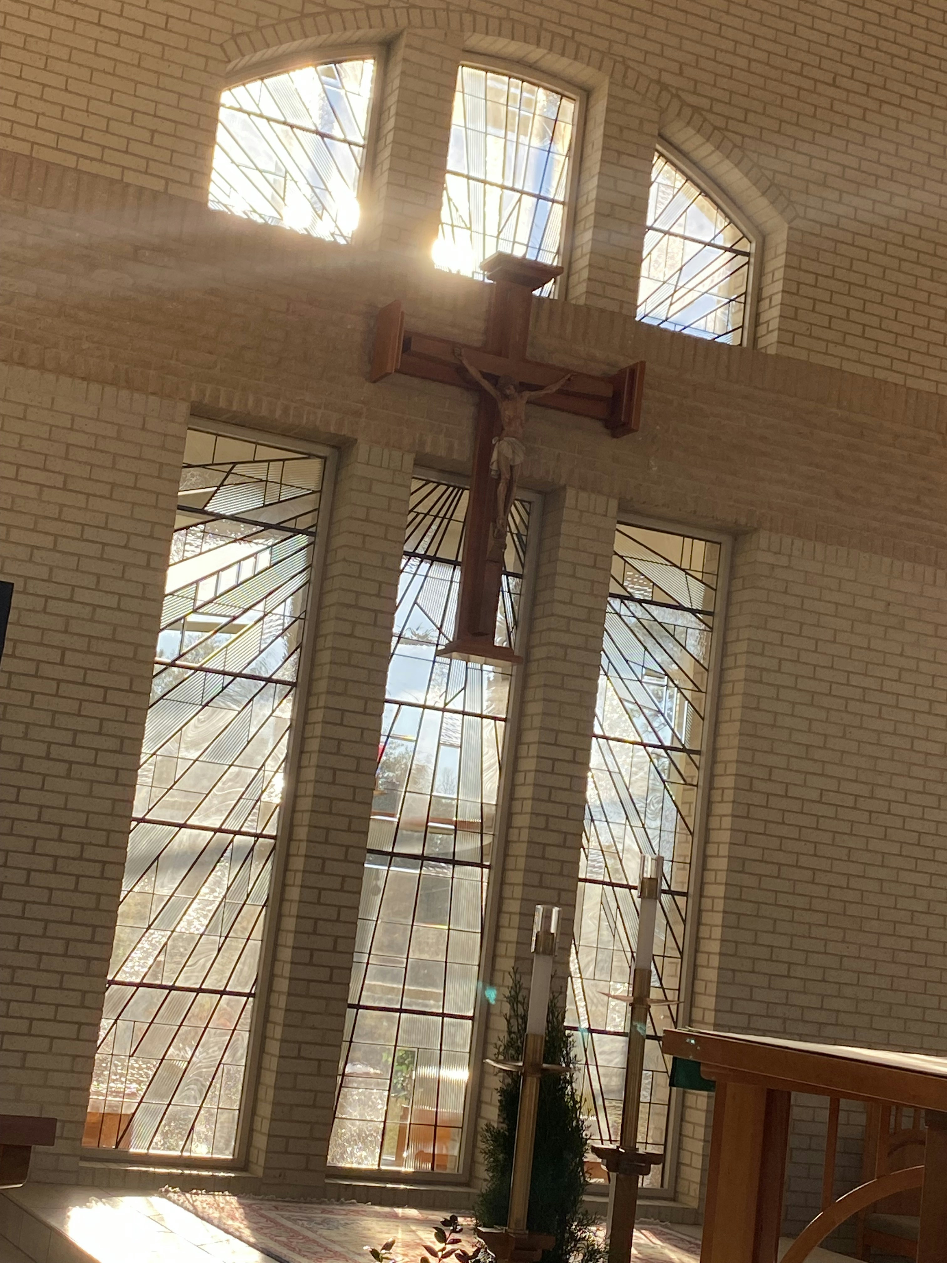 Sunlight streaming through stained glass windows inside Calvary Church sanctuary during a morning service.