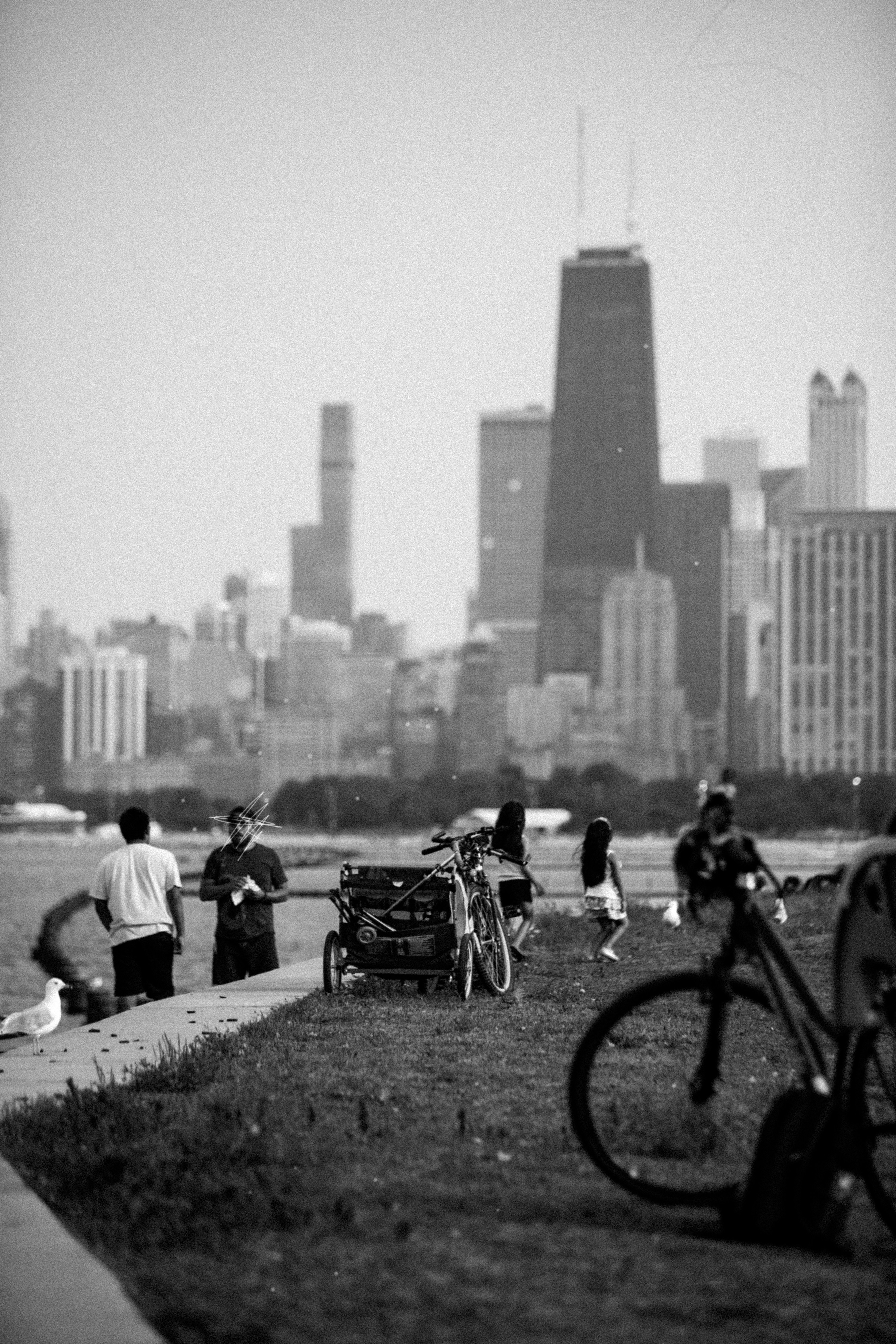 a black and white photo of people and bicycles