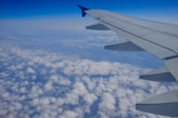 the wing of an airplane flying above the clouds
