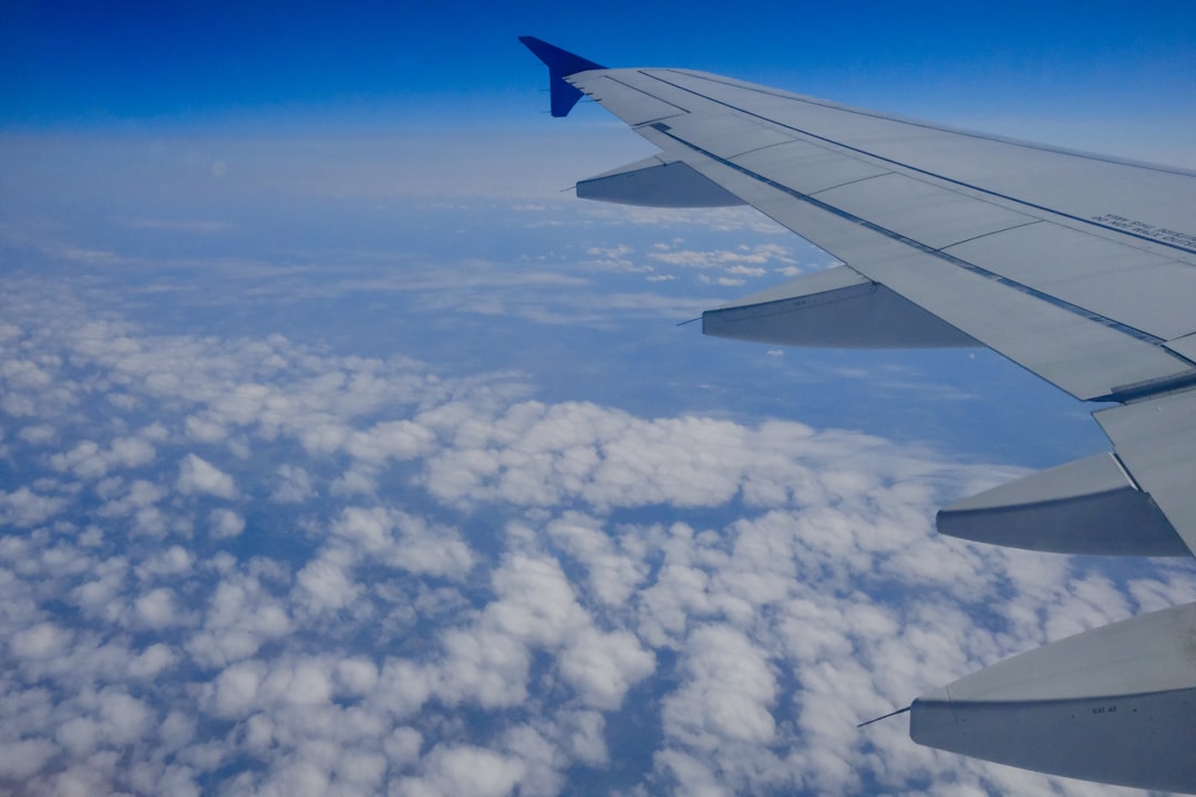 the wing of an airplane flying above the clouds, Airplane window flying south over Tennessee.