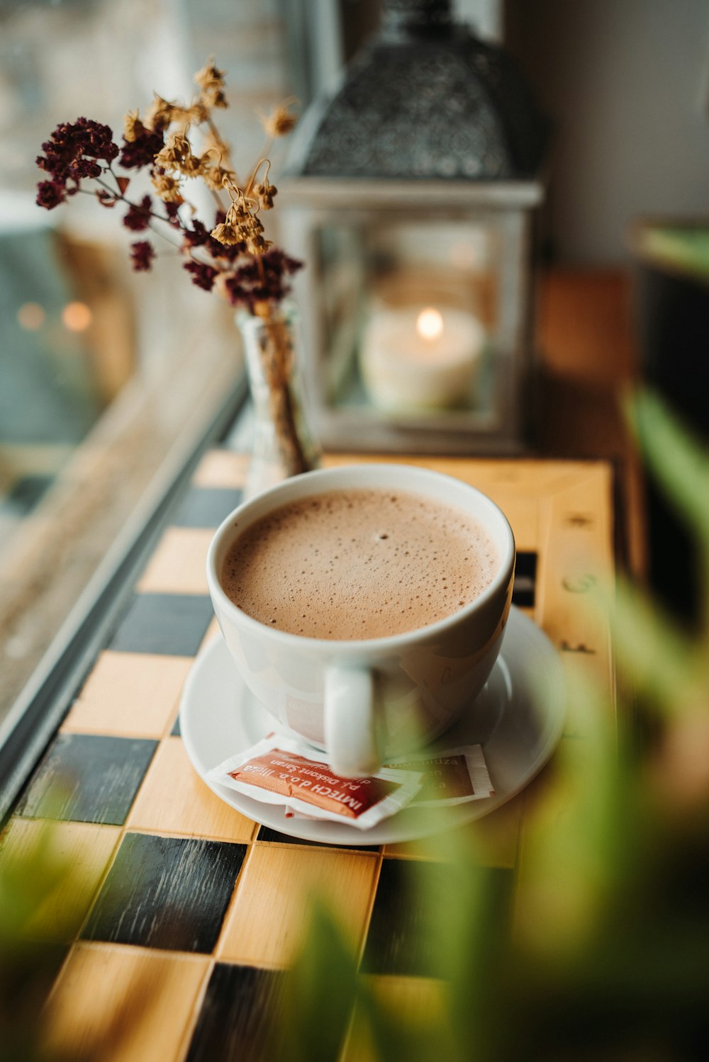 a cup of coffee sitting on top of a wooden table