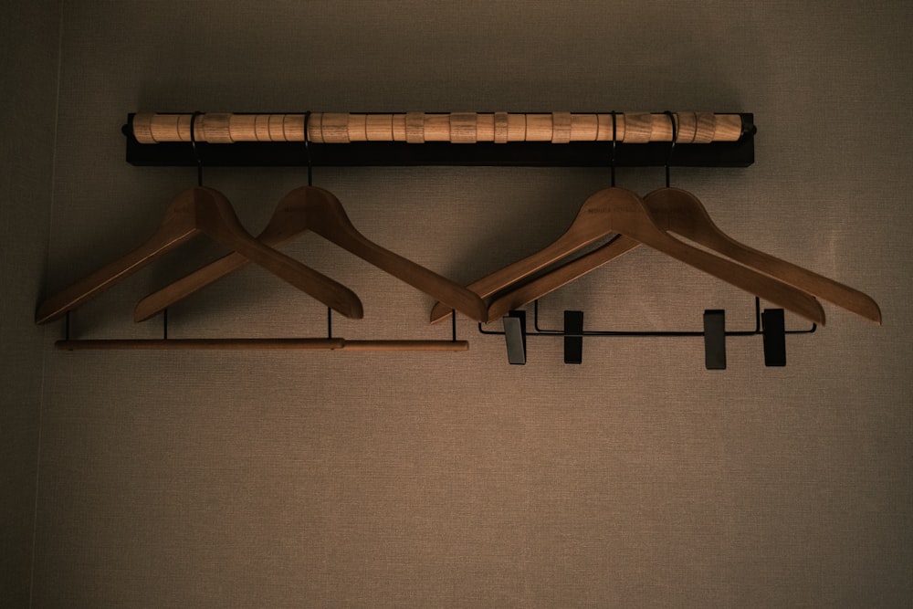 a couple of wooden clothes hangers on a wall