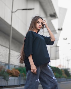 a woman is walking down the street with her hand on her head
