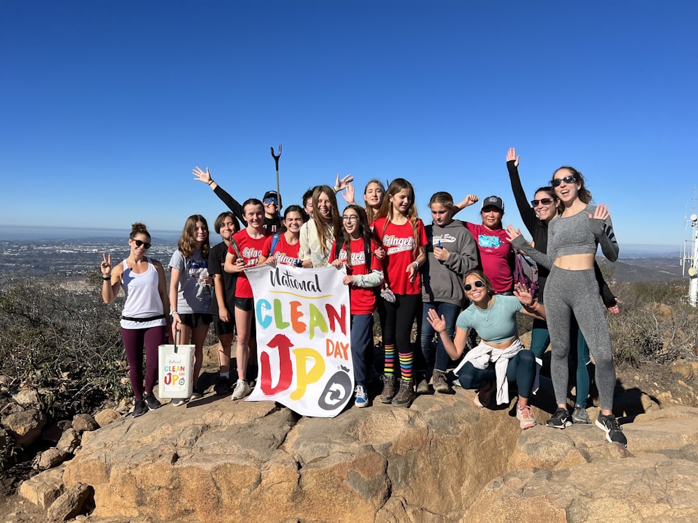 a group of people standing on top of a mountain