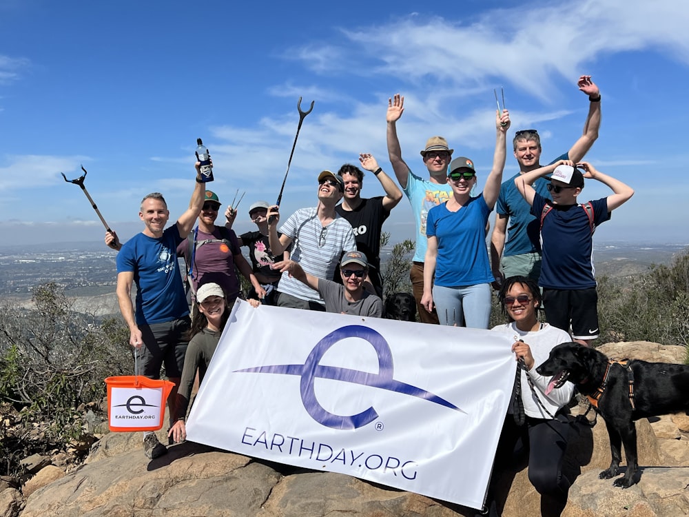 a group of people standing on top of a mountain