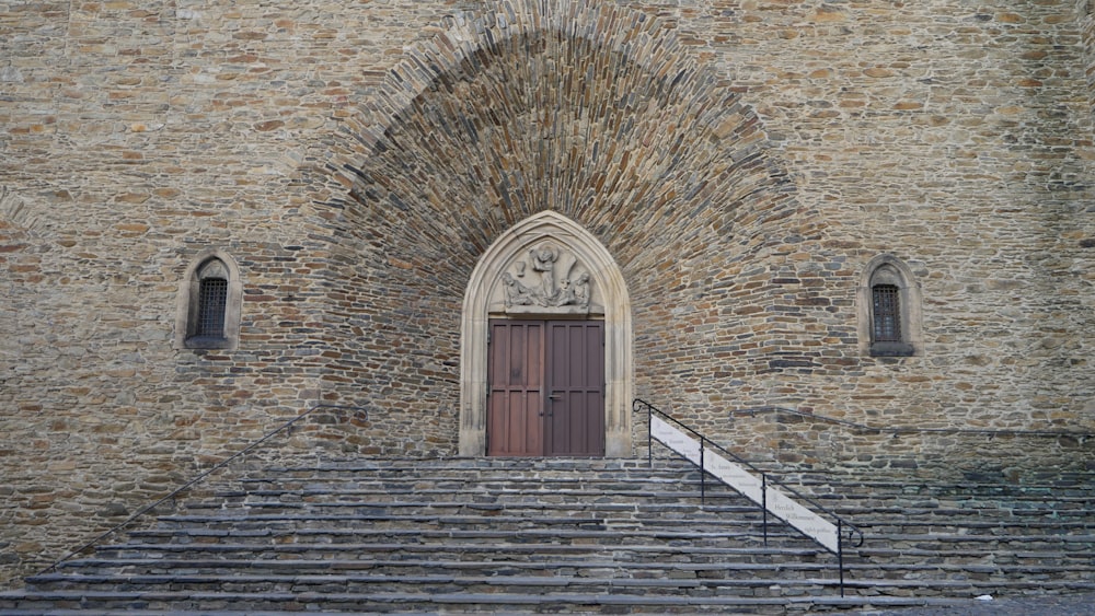 a stone building with steps leading up to a door