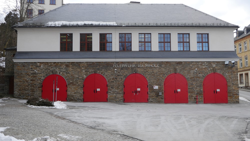 a row of red doors in front of a building