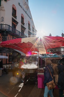 A sunny marketplace scene with people enjoying gourmet food.