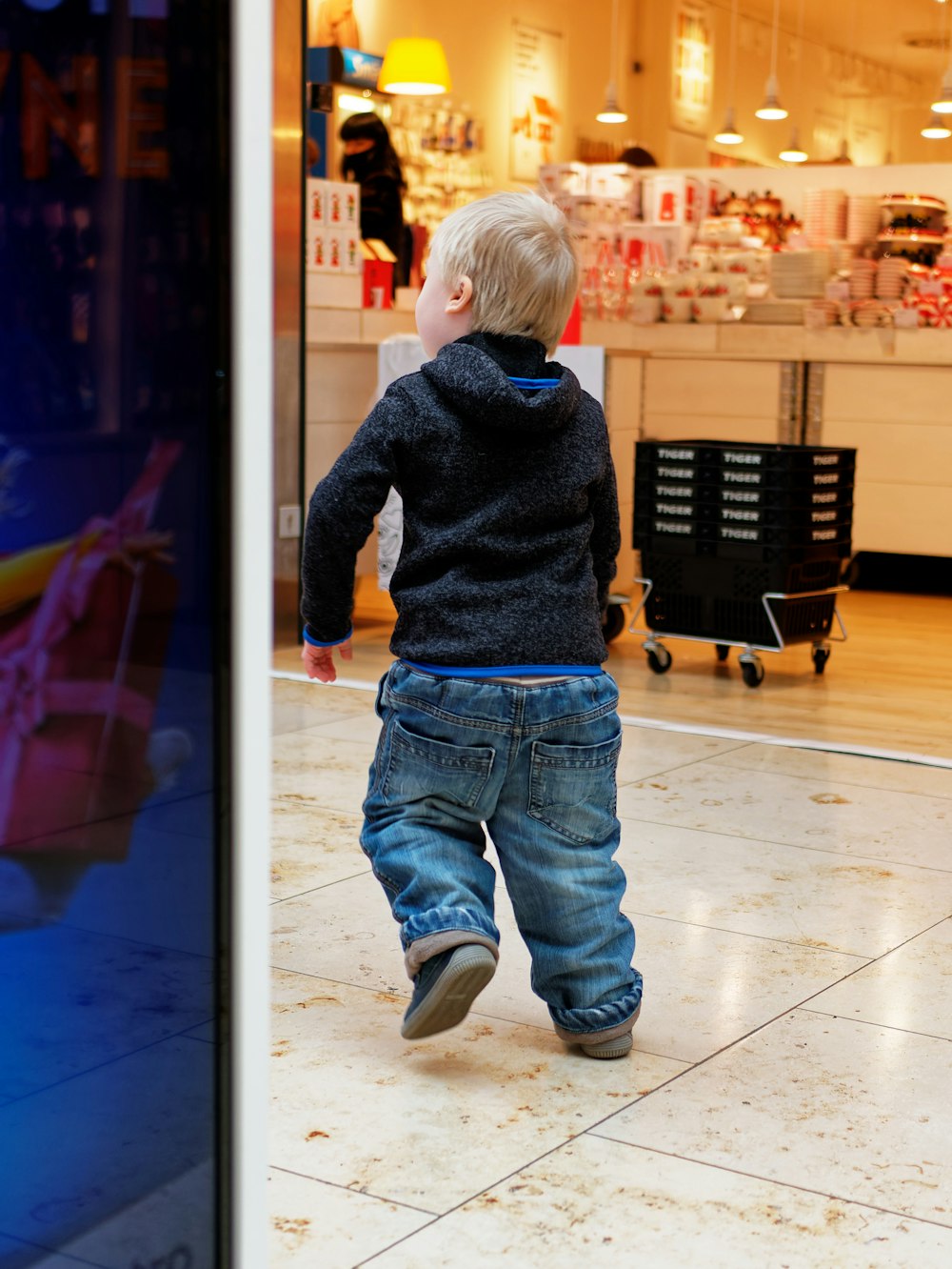 a little boy that is standing in a store