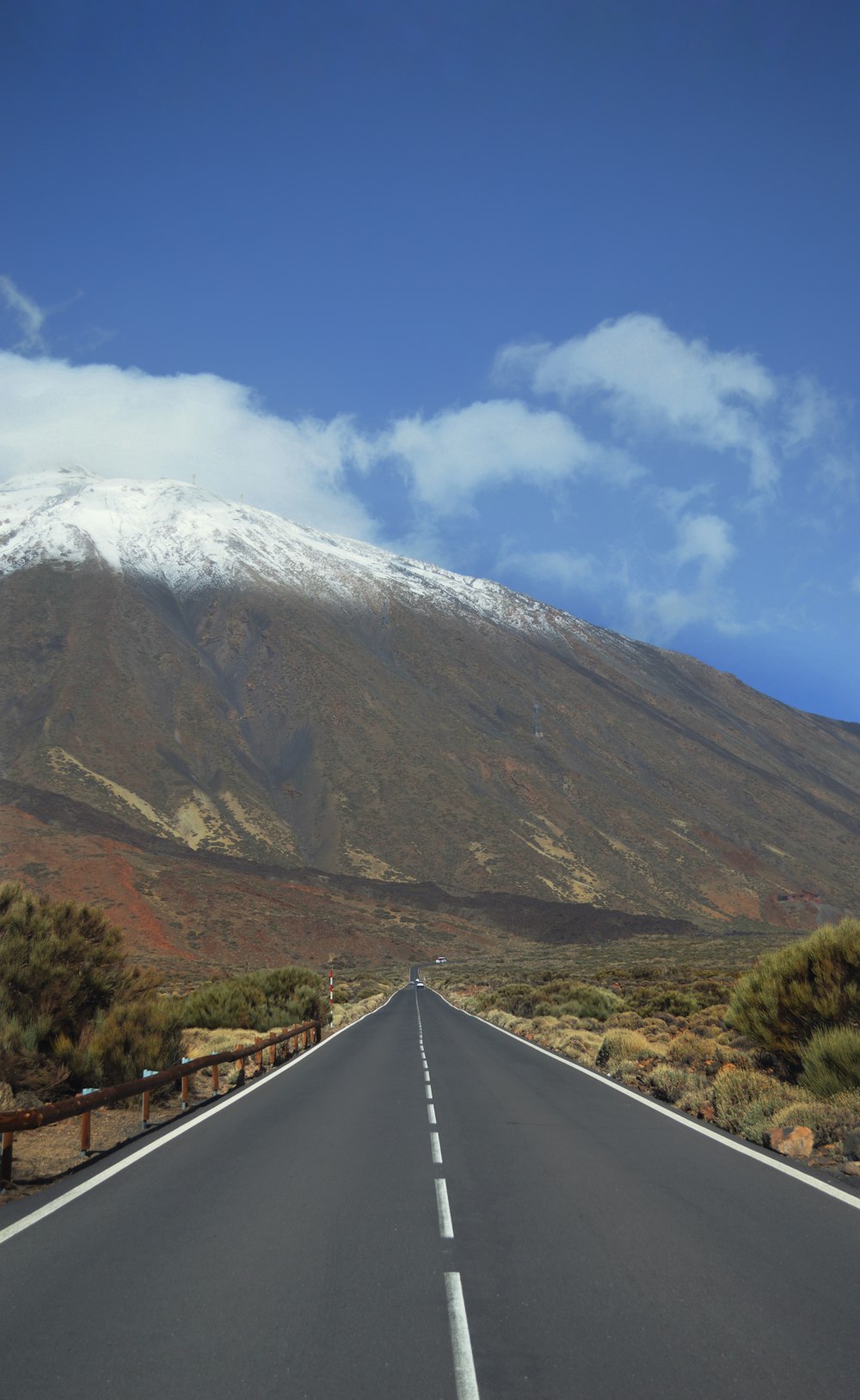 a long road with a mountain in the background