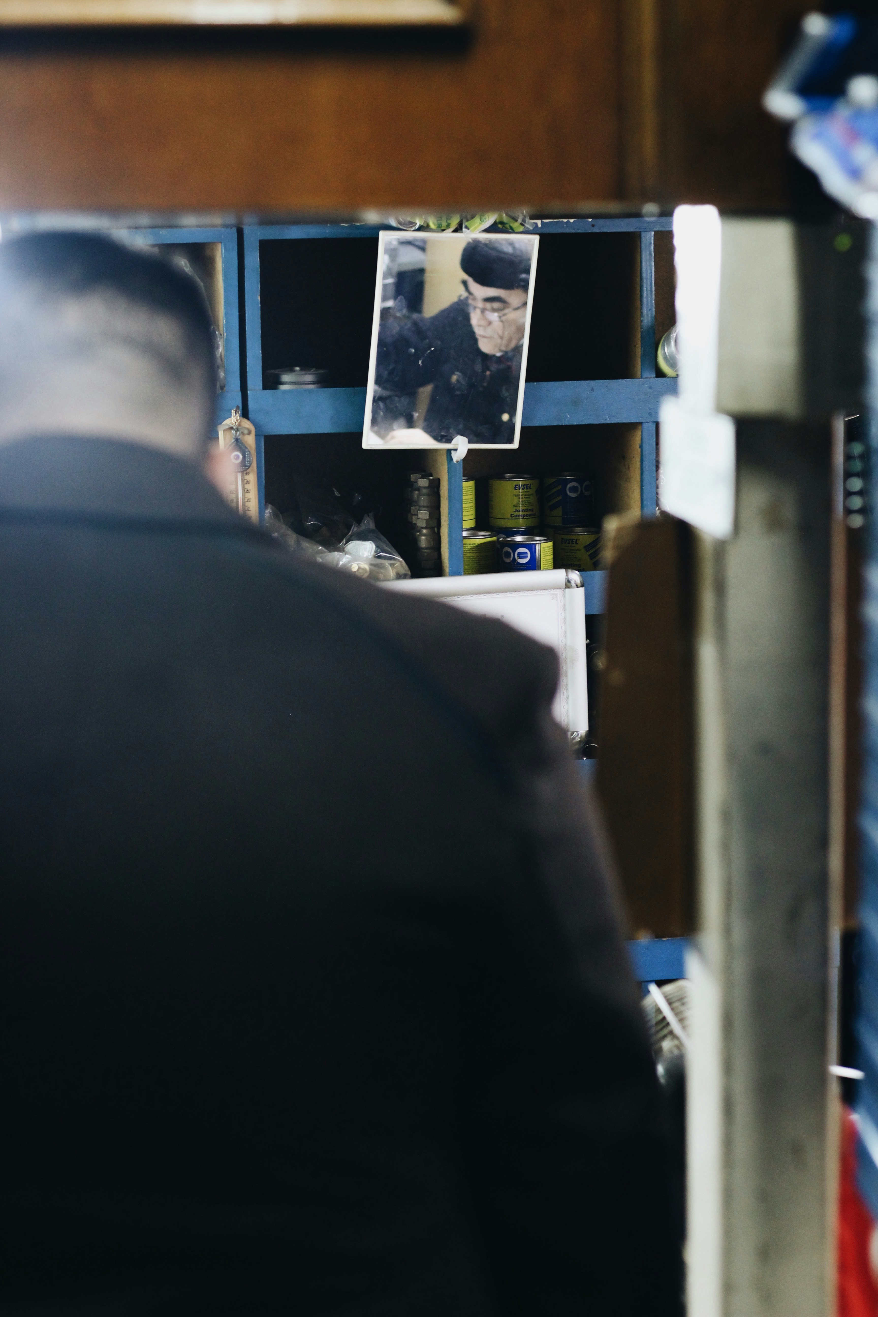 a man in a suit looking at a picture of himself