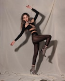 A model wearing high-performance gear in a dynamic pose.