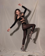 A dynamic photo of a model posing during a professional photoshoot.