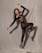 A person is posing in a dynamic fashion stance against a neutral backdrop. The outfit consists of a black, cut-out top and sheer leggings, paired with high-heeled, mesh boots. The lighting creates a dramatic shadow on the draped fabric background, highlighting the elegant pose.