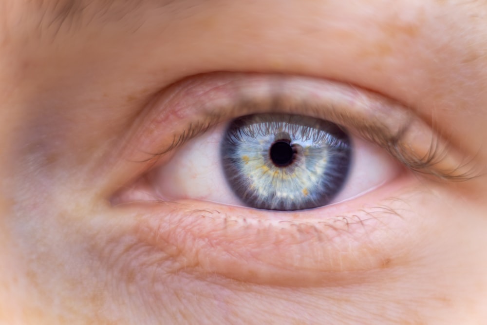 a close up of a person's blue eye