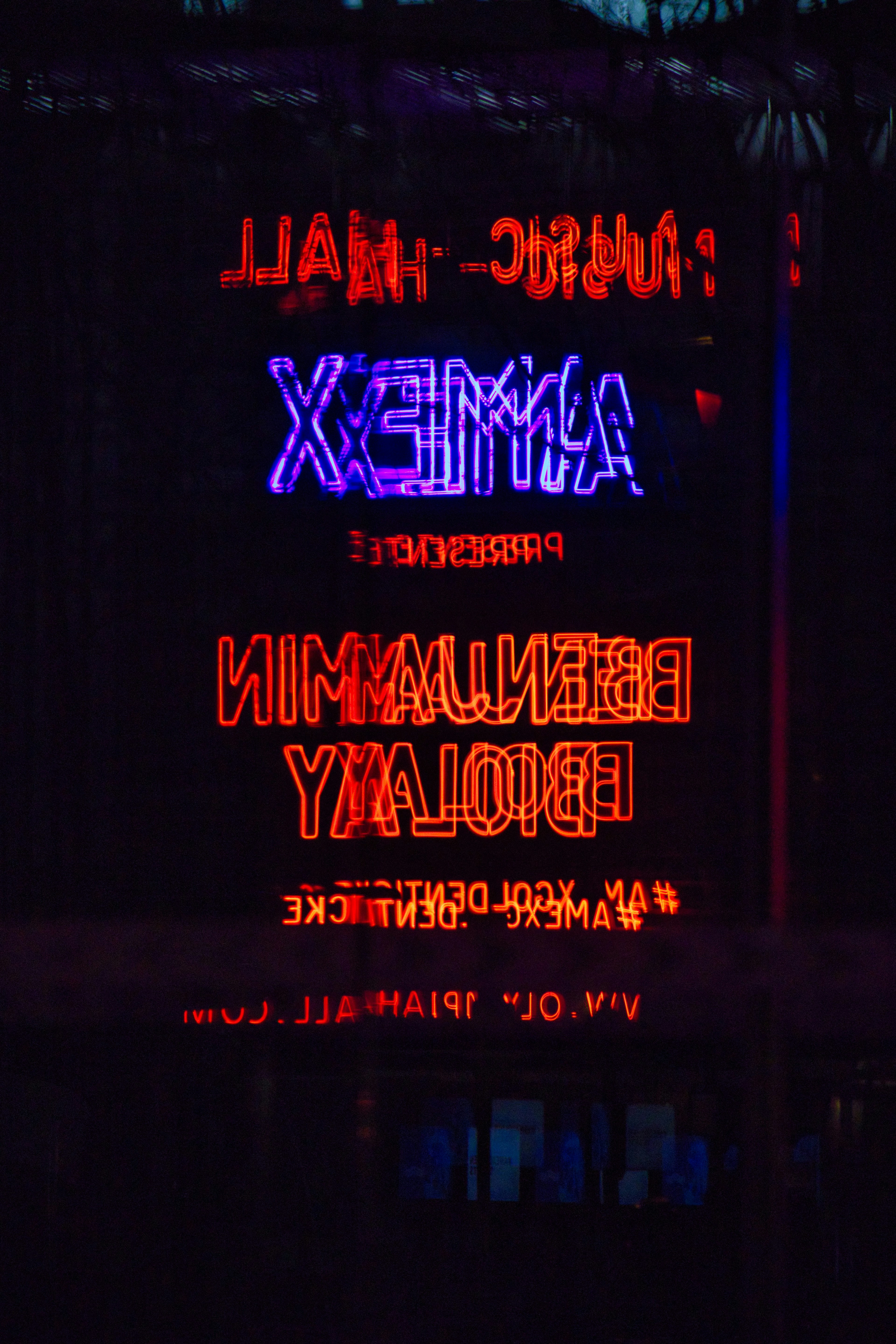 a neon sign is lit up in the dark