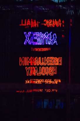 a neon sign is lit up in the dark