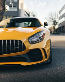 Close-up shot of a sleek black Ford Mustang with a newly designed front splitter in an urban setting.
