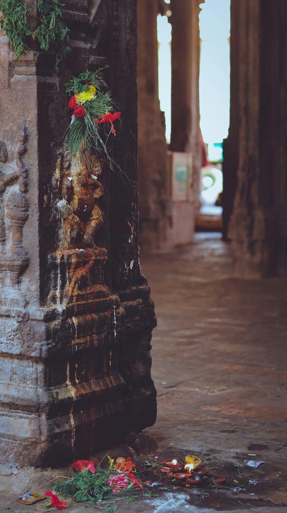 a pillar with a bunch of flowers on it