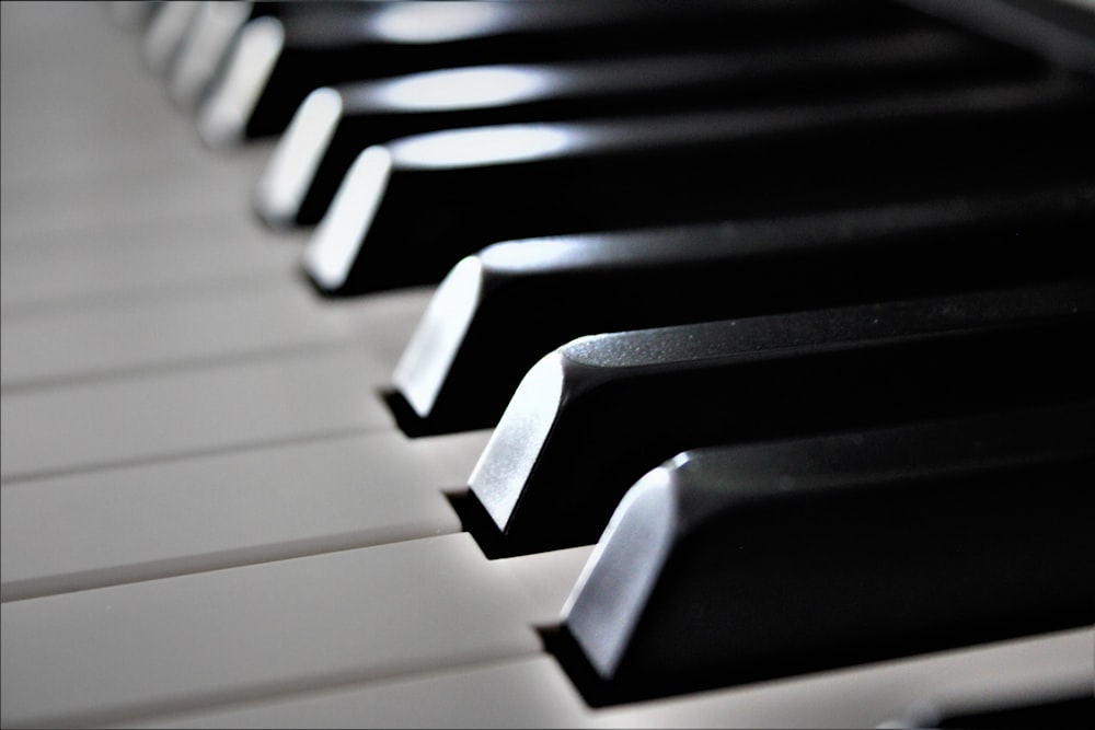 a close up of a black and white piano