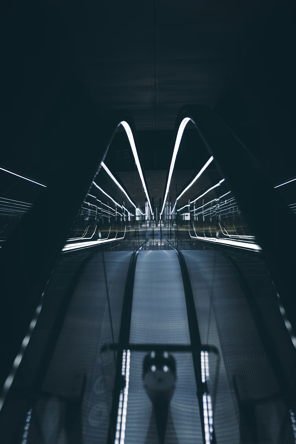 an escalator in a subway station at night