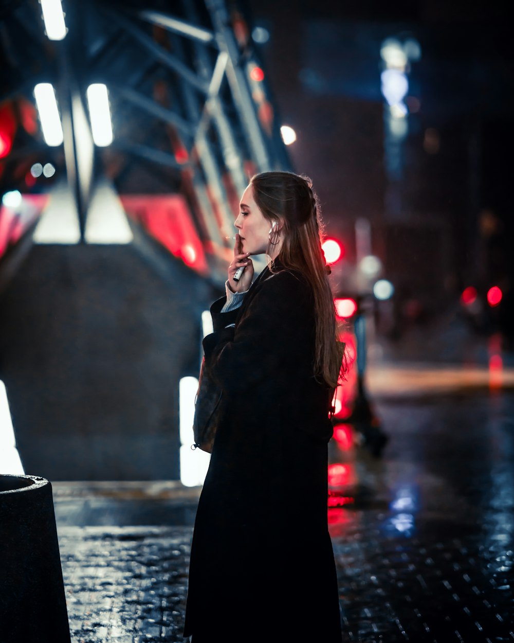 a woman standing on a sidewalk talking on a cell phone