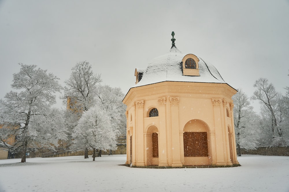 a small building with a clock on the top of it