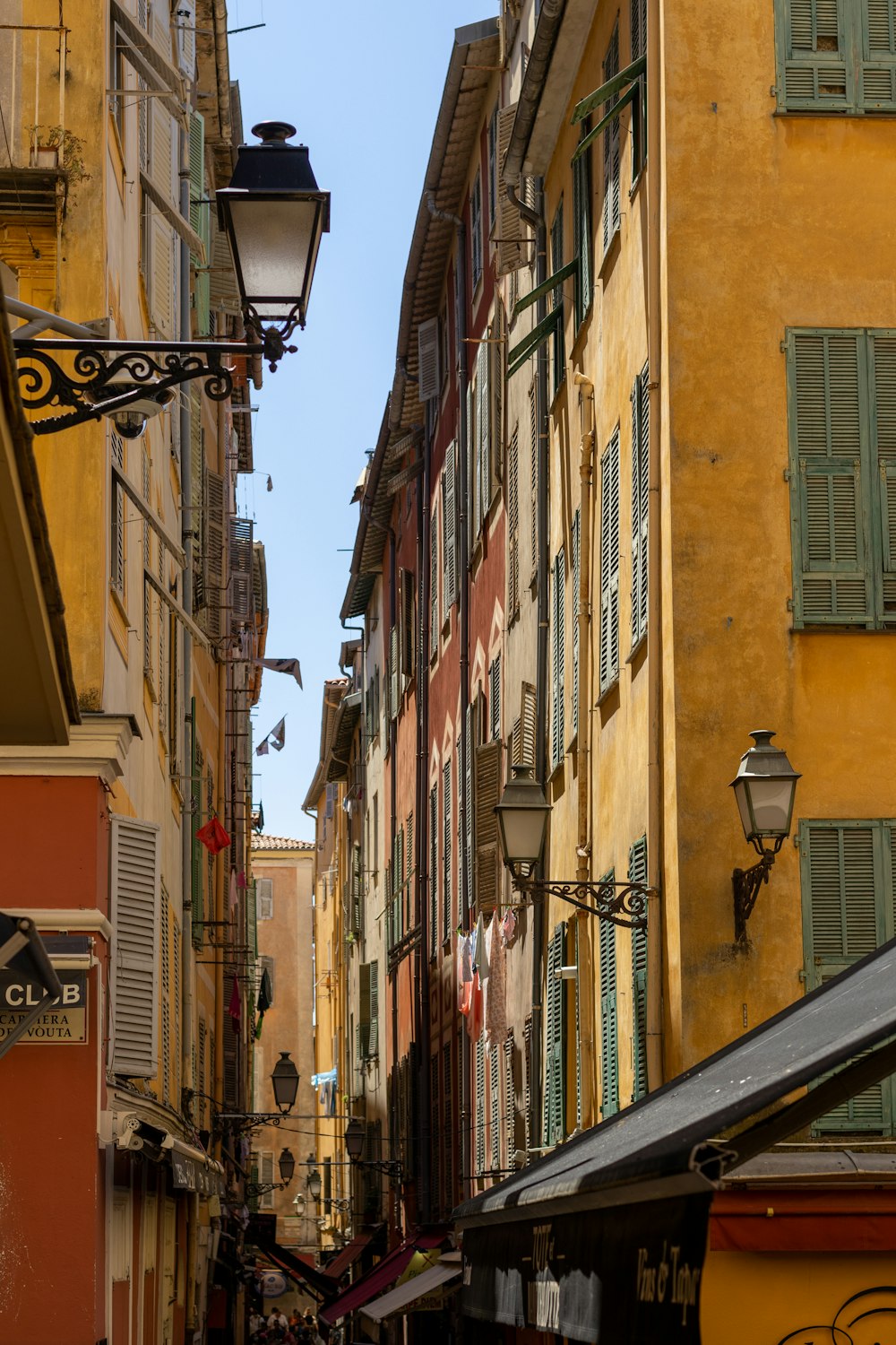 a narrow city street lined with tall buildings