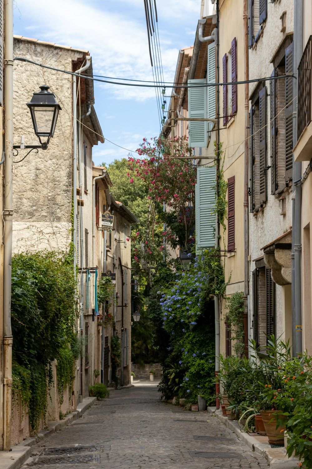 a narrow alley way with a lamp post