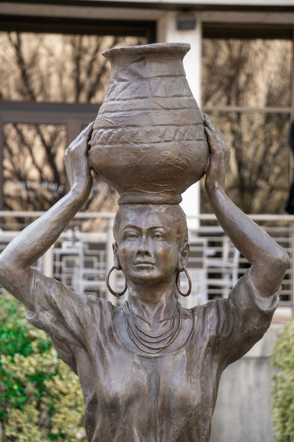 a statue of a woman holding a vase on her head