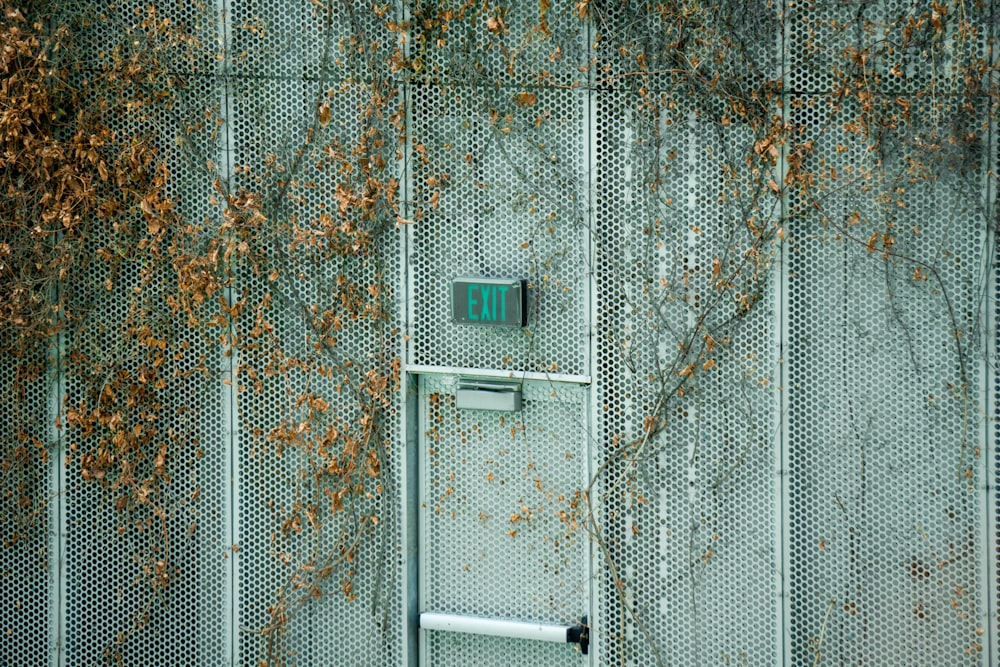 a metal door with a green handle on it