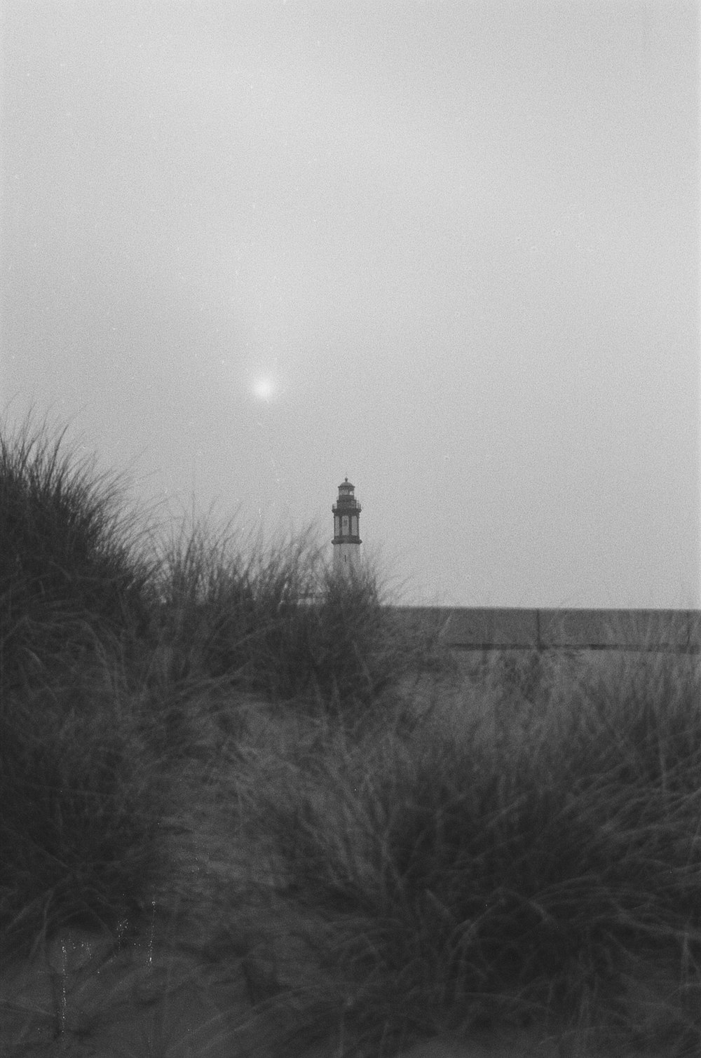 a black and white photo of a lighthouse