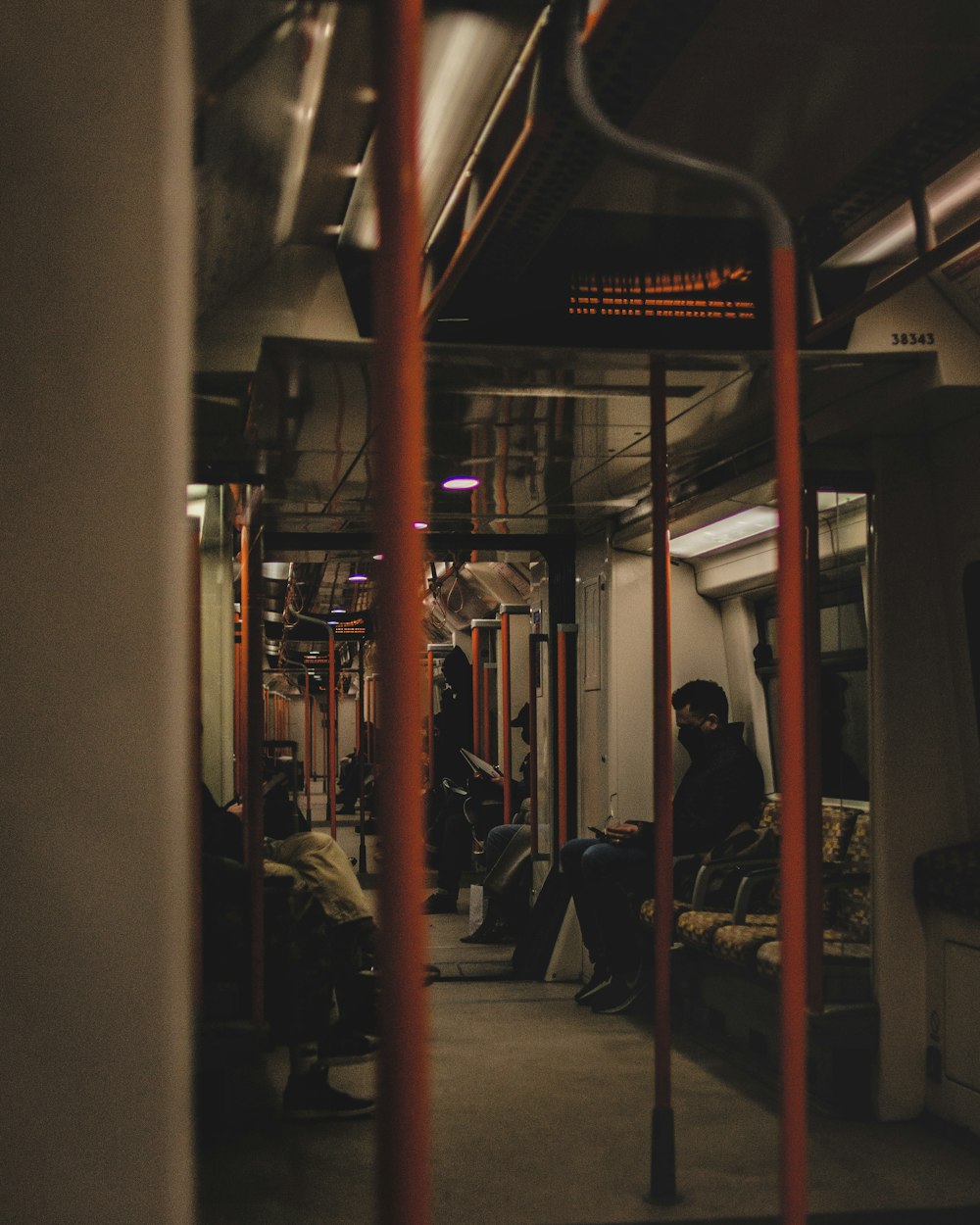 a subway car with people sitting on the seats