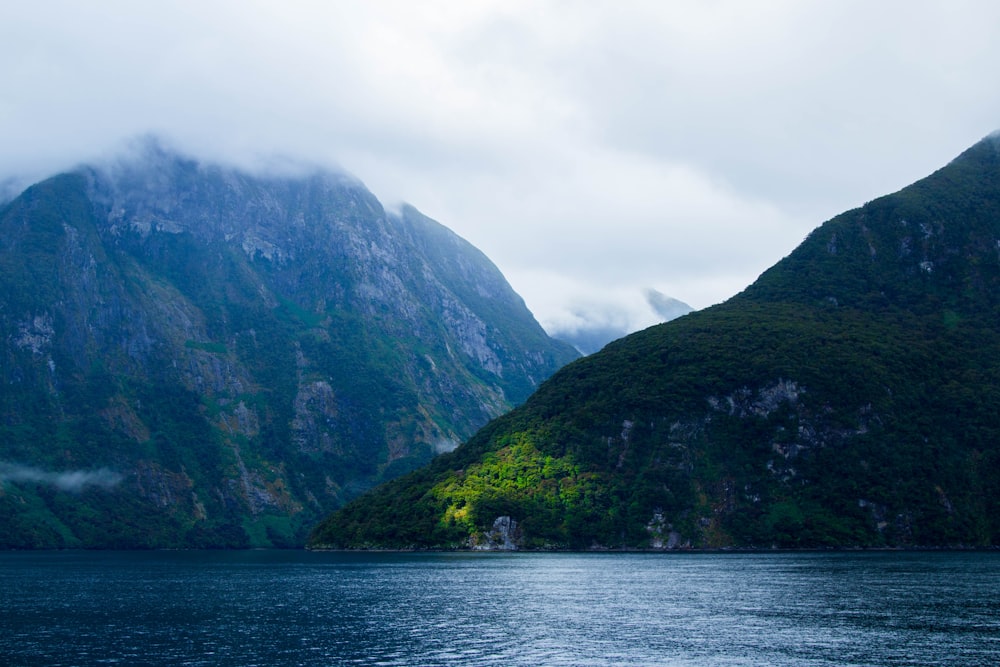 a body of water with mountains in the background