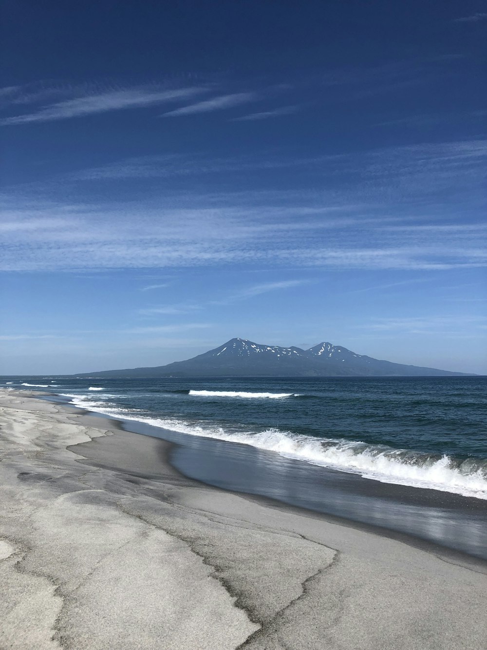 a view of a beach with a mountain in the distance