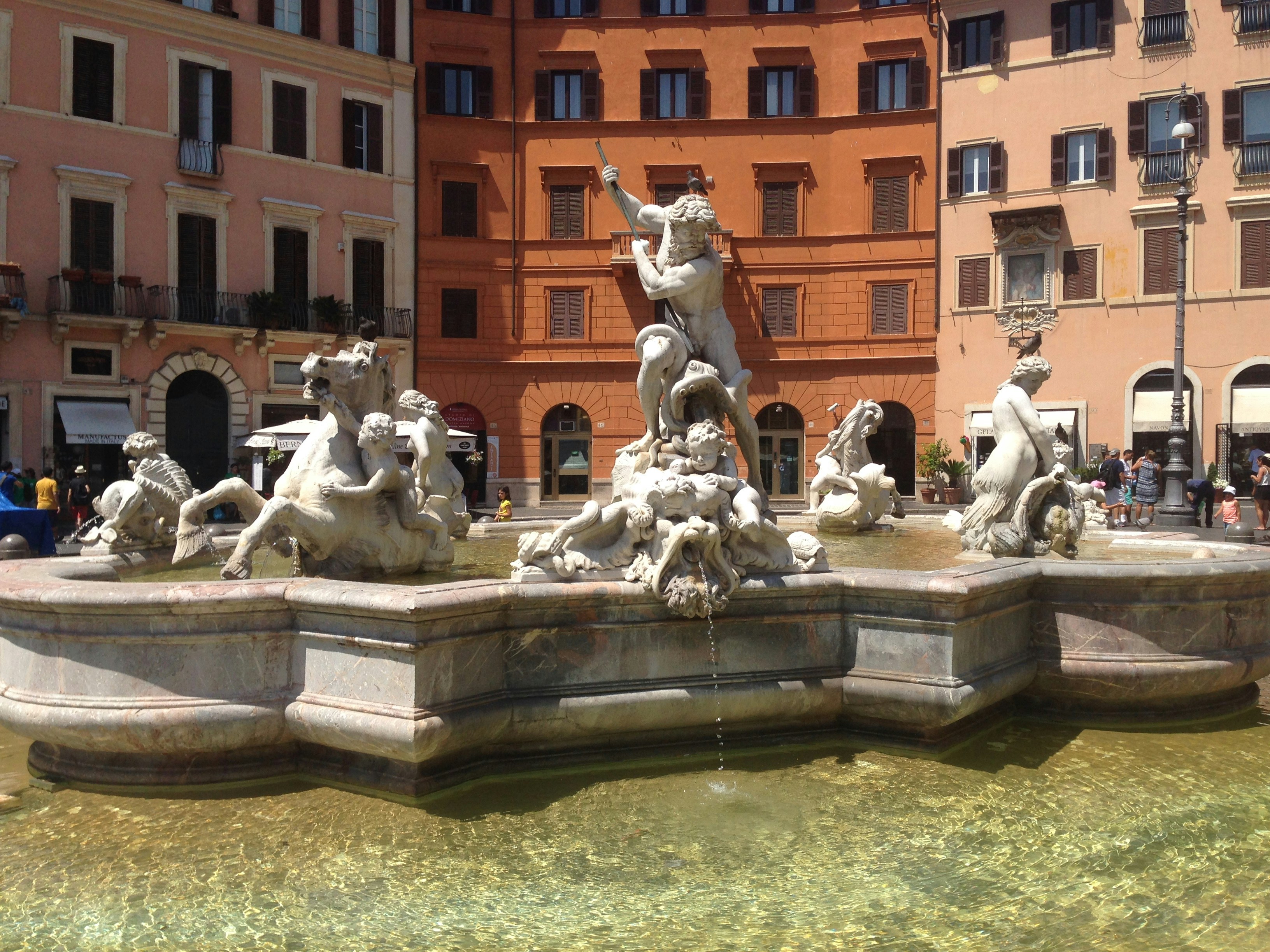 a fountain with statues of animals and people around it
