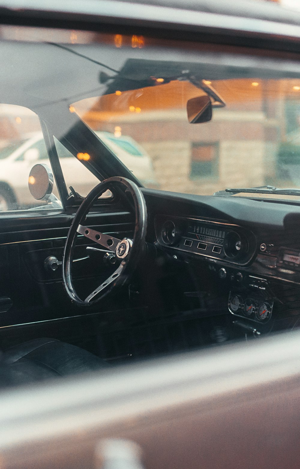 the interior of a car with a steering wheel and dashboard