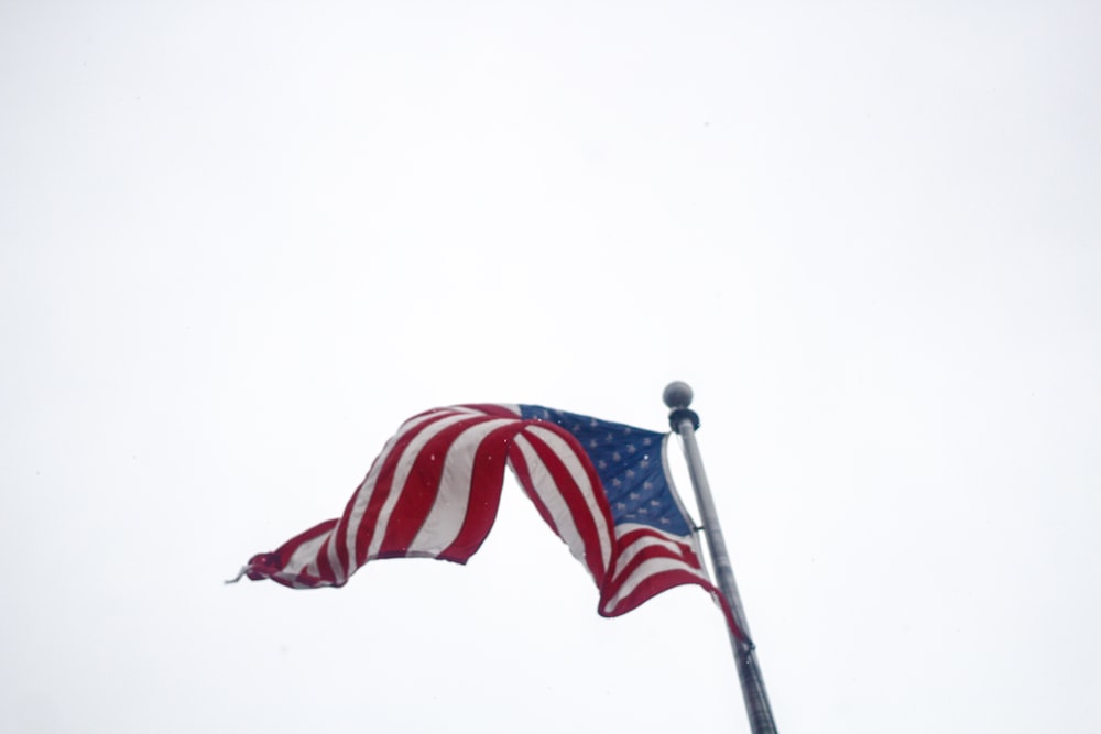 an american flag is flying in the wind