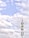 A telecommunications tower stands against a backdrop of a partly cloudy sky. The structure is equipped with various antennas and equipment, suggesting its use for communication purposes.