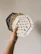 Close-up of handcrafted wooden coasters with natural grain patterns on a cozy table.