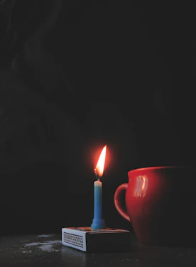 A cozy candlelit scene featuring a Bluegrass Glow candle beside a vintage Kentucky map.