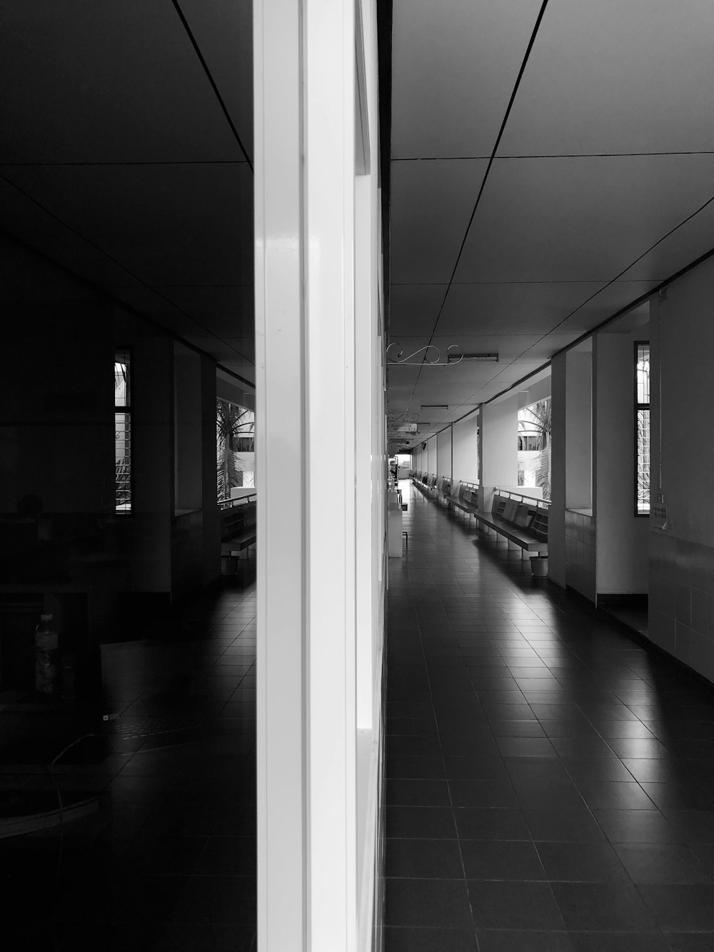 a black and white photo of a long hallway