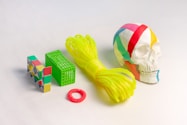 a skull, a ball of yarn, and a ring on a white surface