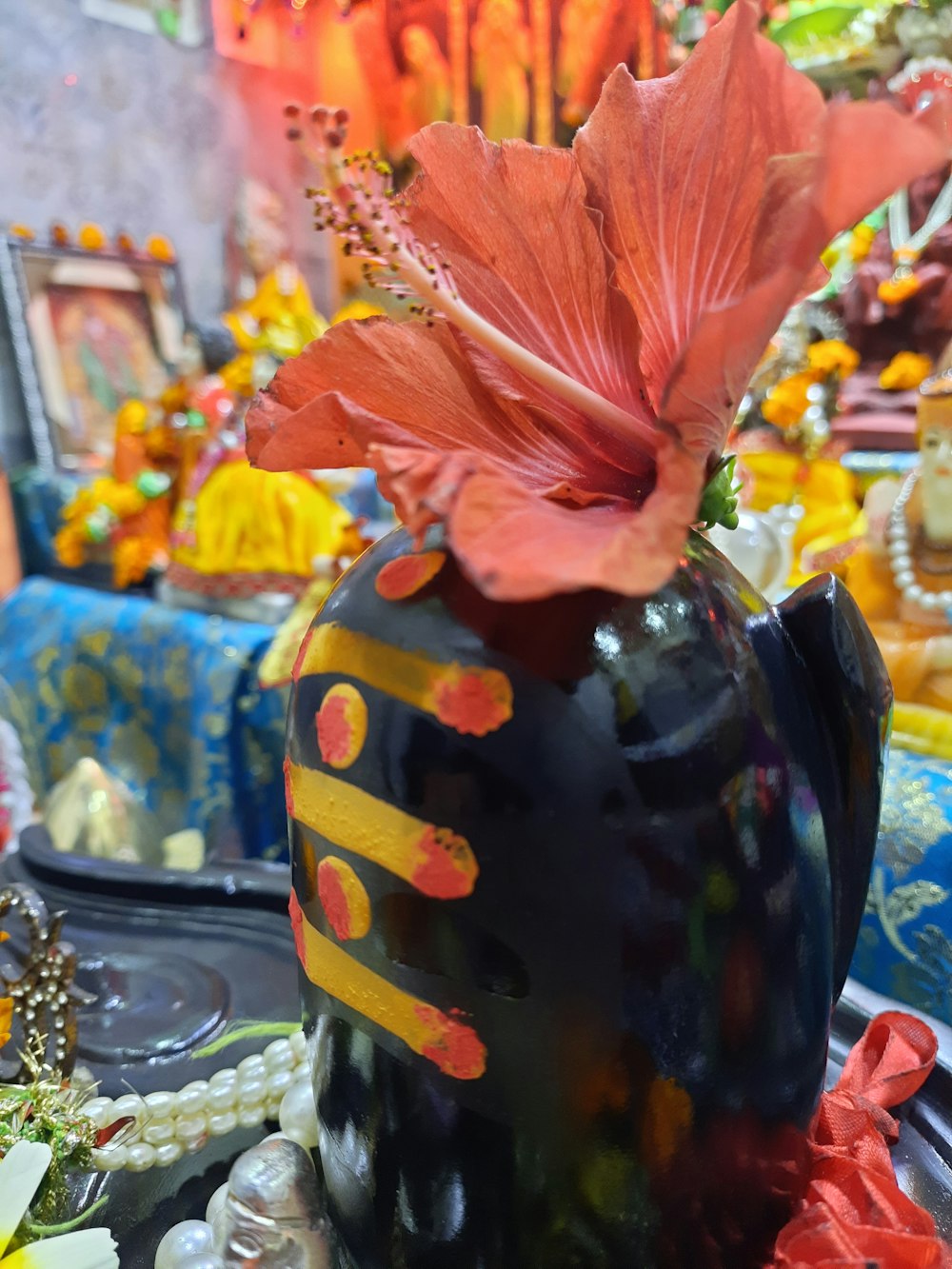 a vase with a flower in it sitting on a table